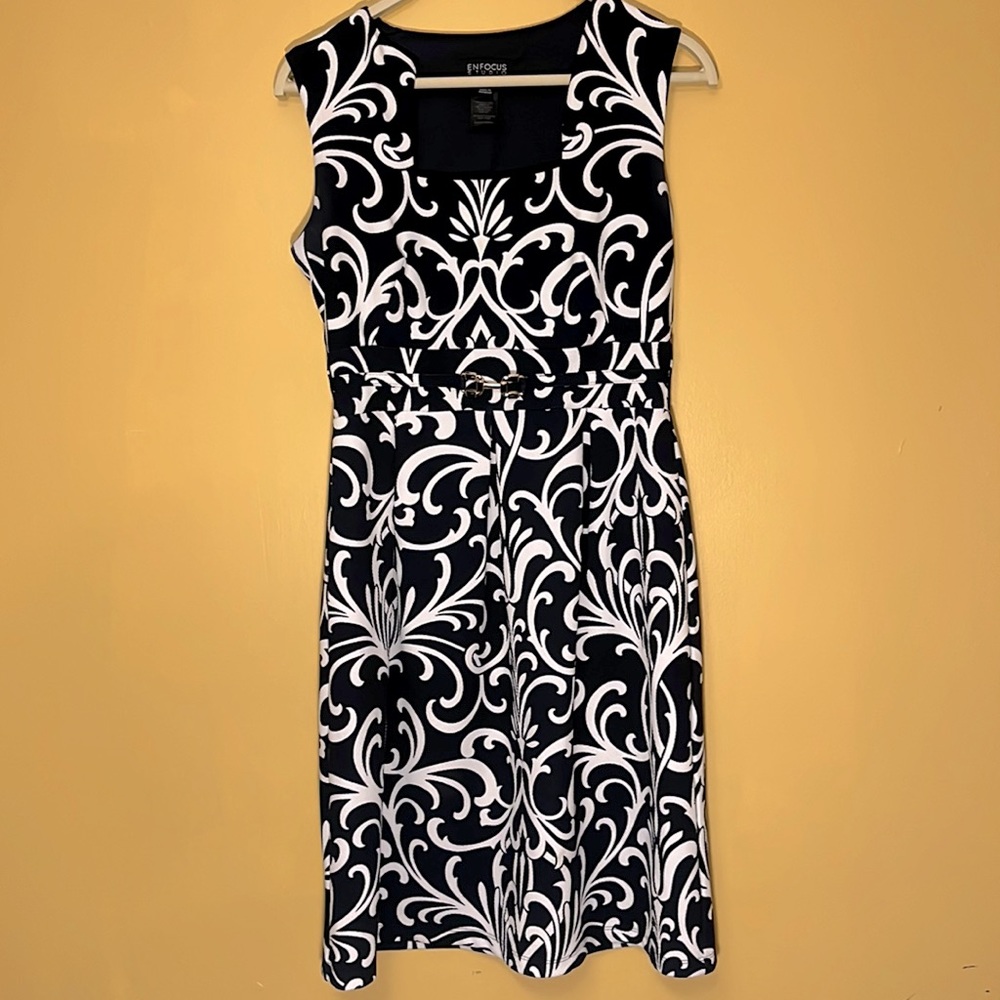 Navy blue dress with square neckline and gold accent on waistline